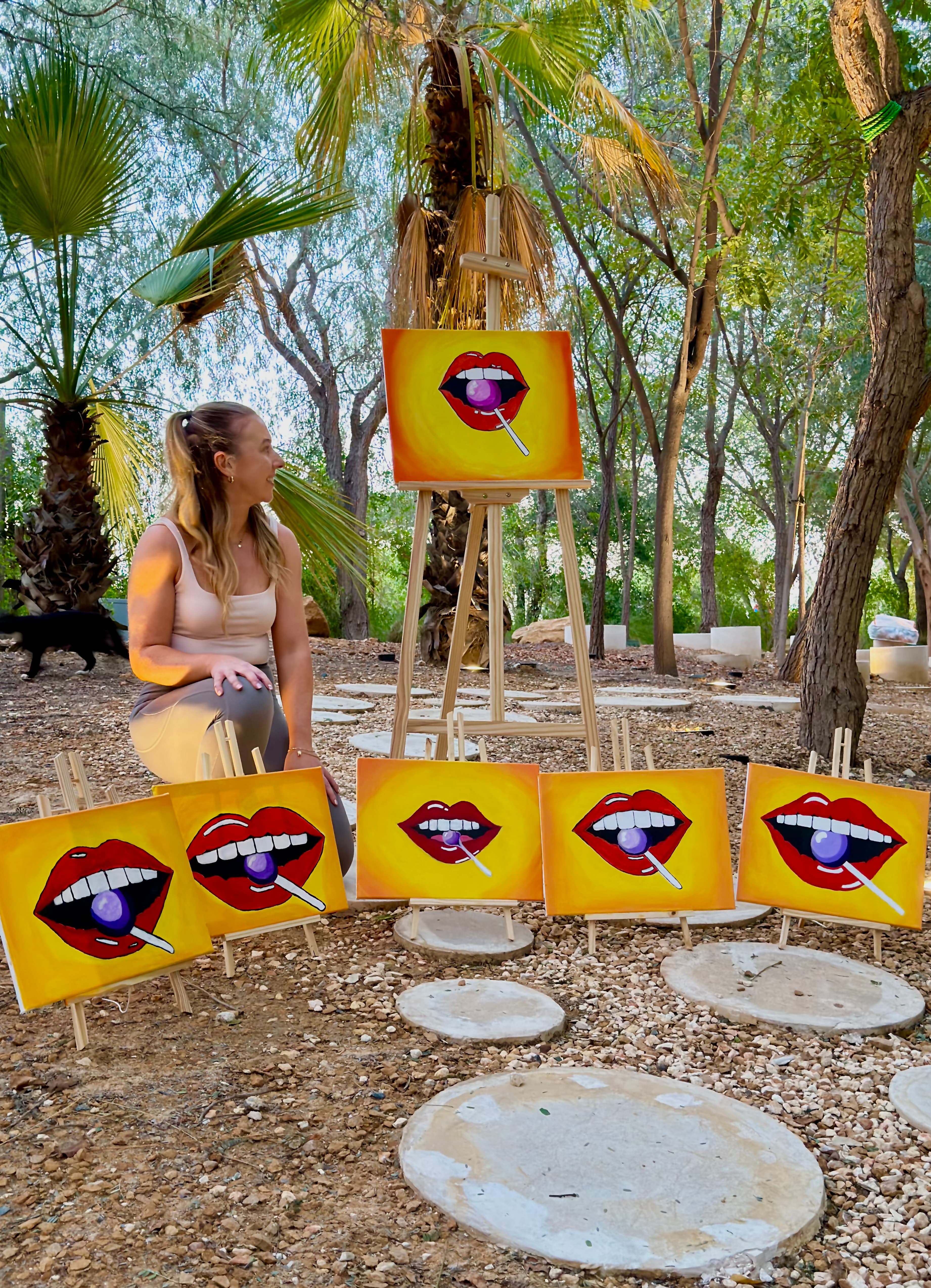 Sinead with her pop art paintings outdoors