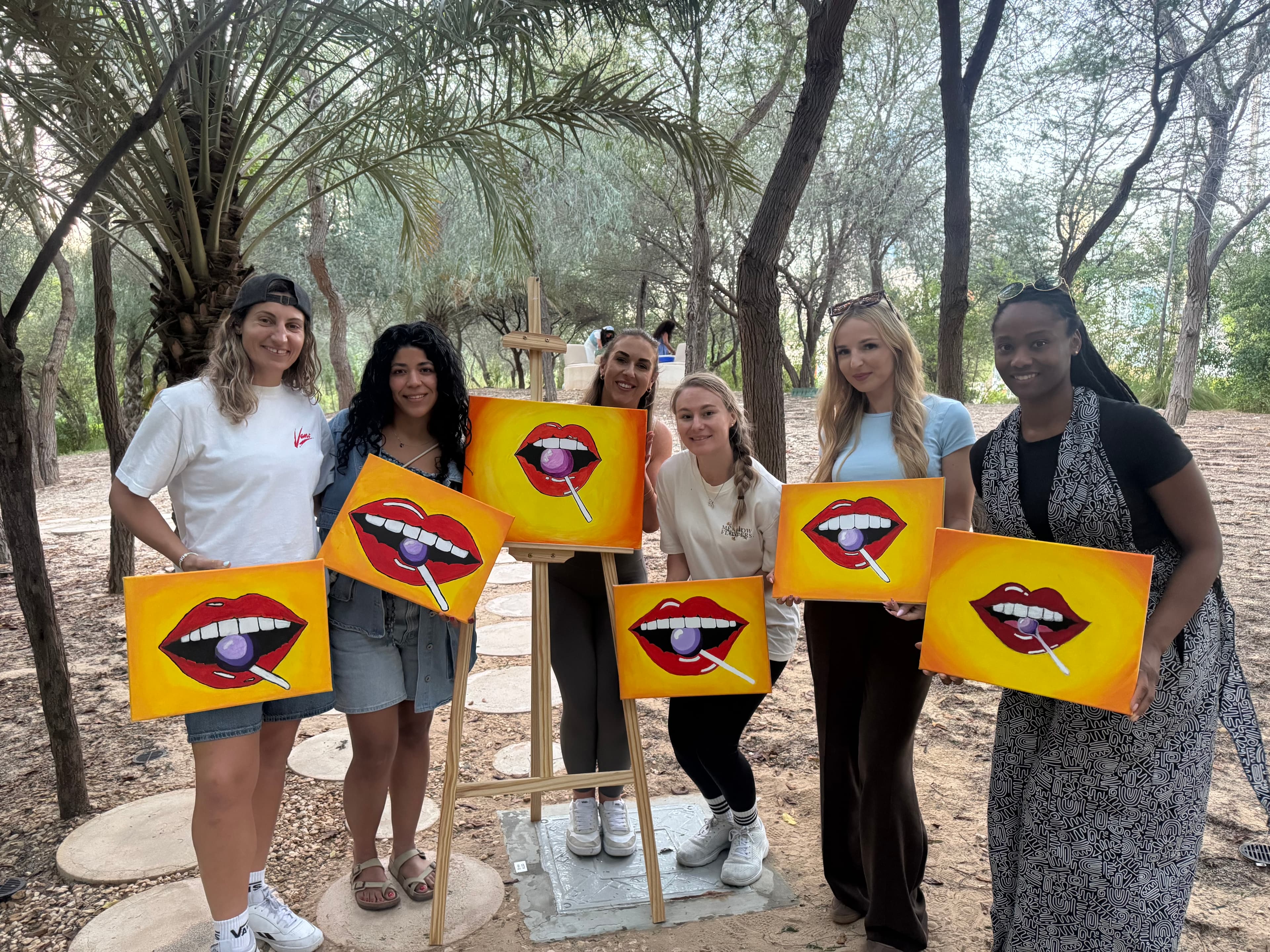 Group of people painting at a private sip and paint event